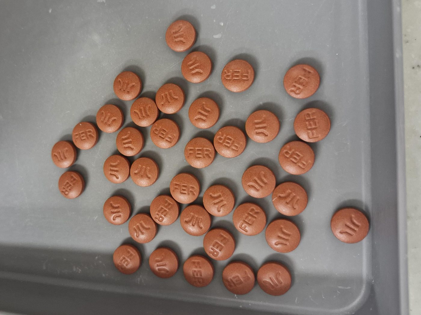 A counting tray of 38 tablets, each outlined in teal and numbered 1 to 38.